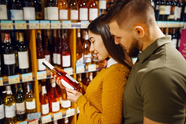 cheerful couple choosing alcohol supermarket man woman buying beverages market 266732 1119
